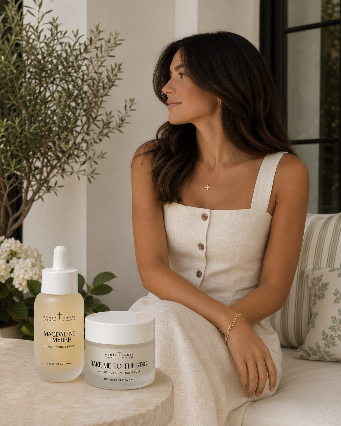 Woman in linen beside the DVNTY HMNTY Anointed Collection — Magdalene + Myrrh and Take Me to the King
